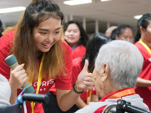 smiling youth interacting with senior smiling youth interacting with senior
